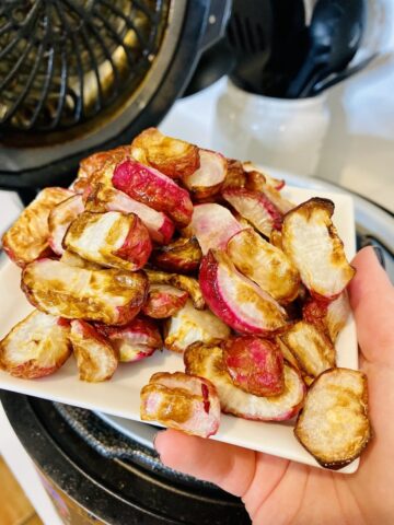 air fryer radishes served on a white plate in a ninja foodi