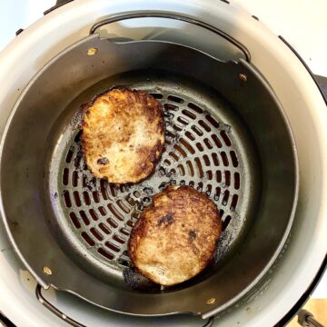 two turkey burgers fully cooked in the air fryer
